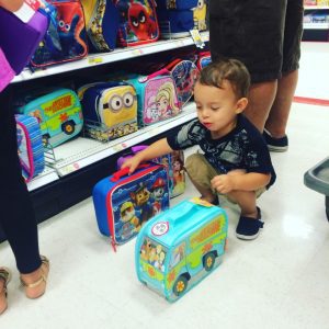 Asher helps pick out ALL the lunch boxes