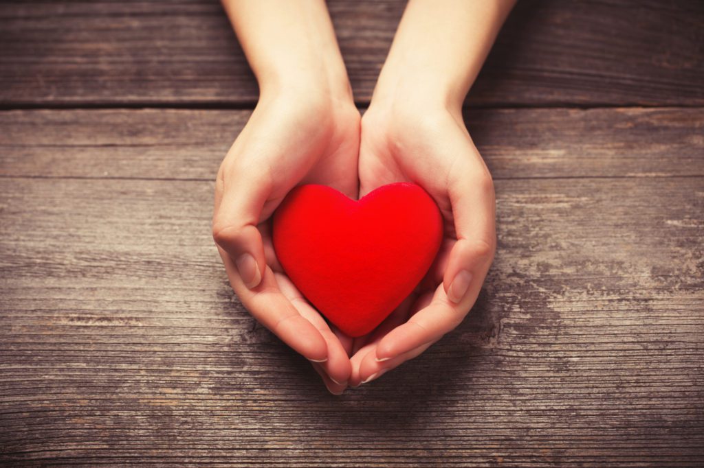 Female hands giving red heart from Albuquerque Moms Blog