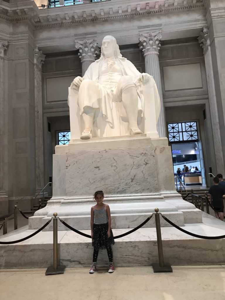 Girl with statue of Benjamin Franklin