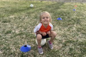 Jo sitting on a soccer ball