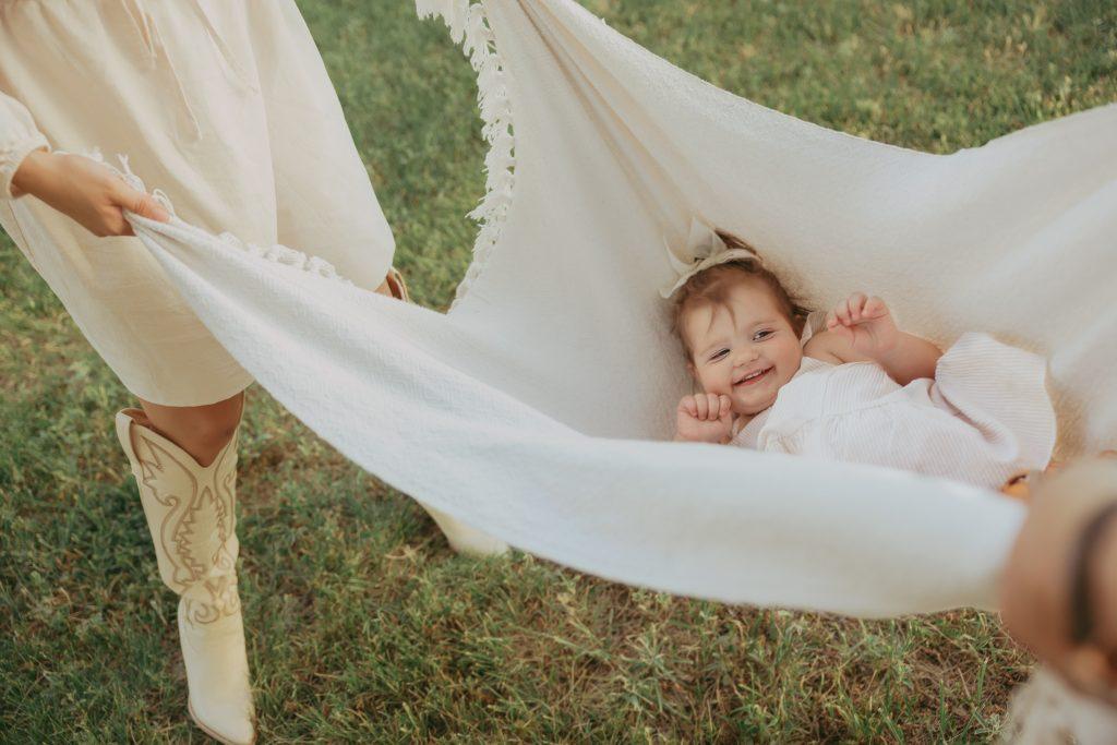 little girl being swung in a blanket