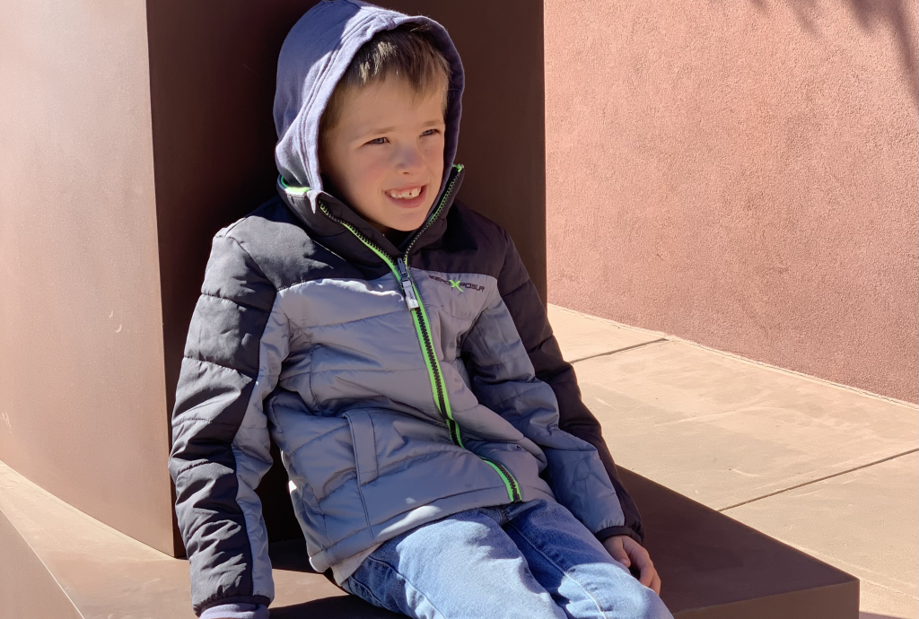 Boy sitting in Santa Fe. Santa Fe with Kids